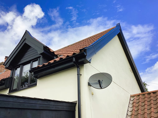 Black uPVC cladding fitted around a garage at a property in Thorndon